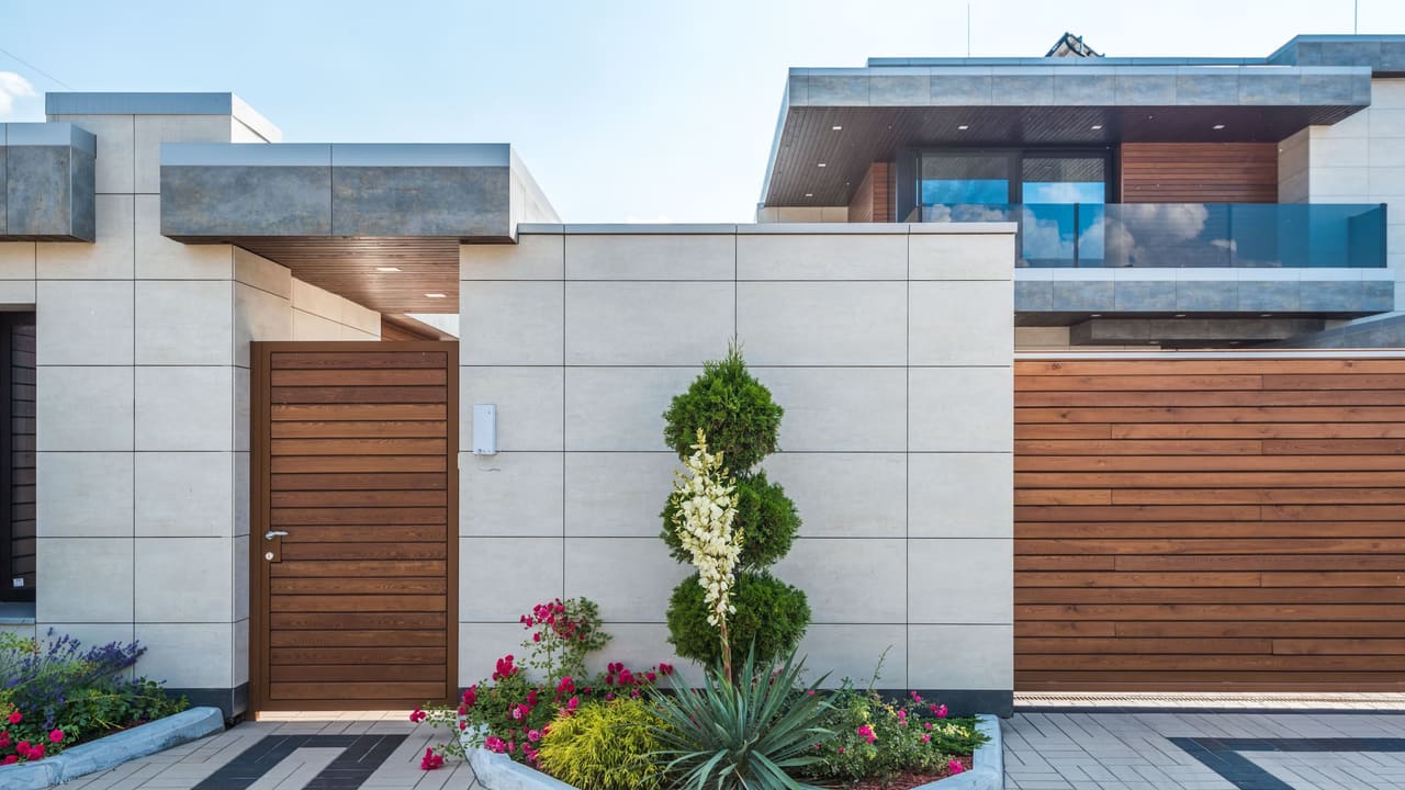 The front of a house with its beds, borders and planting finished